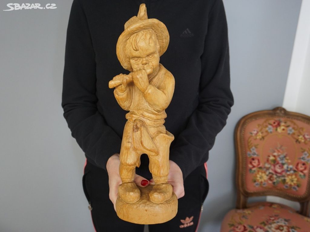 Dřevěná socha chlapce s píšťalou